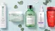 Image of Biolage, Keratase, and L'Oreal shampoo bottles on a light blue background with green leaves, white flower petals, and water droplets