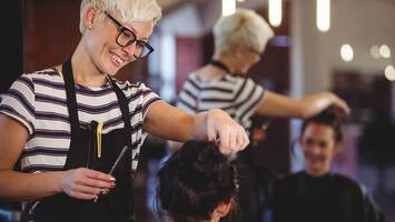 client and hair stylist in salon