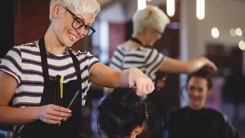 client and hair stylist in salon