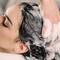 woman getting hair shampooed best moisturizing shampoos