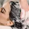 woman getting hair shampooed best moisturizing shampoos