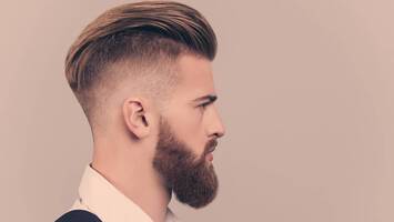man with slicked back haircut high and tight haircuts
