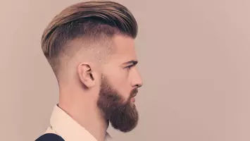 man with slicked back haircut high and tight haircuts
