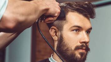man gets his hair cut