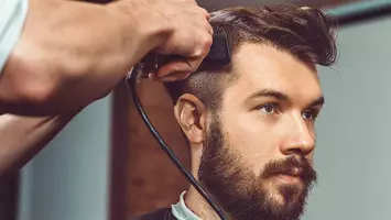 man gets his hair cut