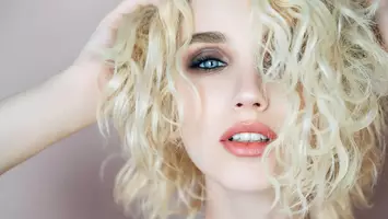 photo of blonde woman with short wavy hairstyle