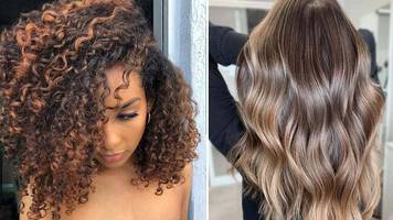 Two women with long curly hair