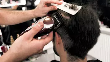 photo of man getting a buzz cut