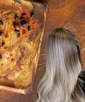 Woman with blonde hair on a background with argan and jojoba oil