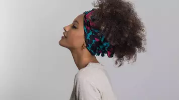 photo of woman with curly hair wearing head wrap accessory