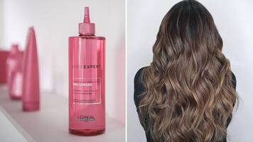 Woman brushing long brunette wavy thick hair