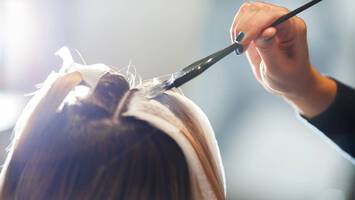photo of hair coloring in salon how to lighten dyed hair