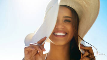woman on the beach wearing a sun hat
