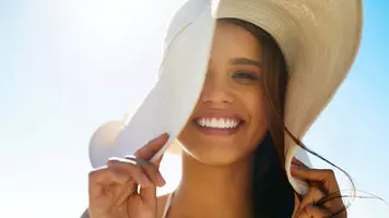 woman on the beach wearing a sun hat