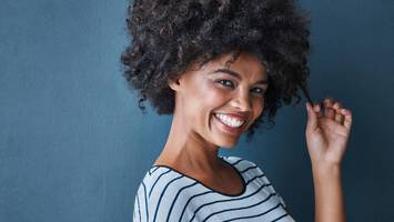 photo of woman with curly hair co-washing