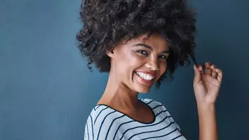 photo of woman with curly hair co-washing
