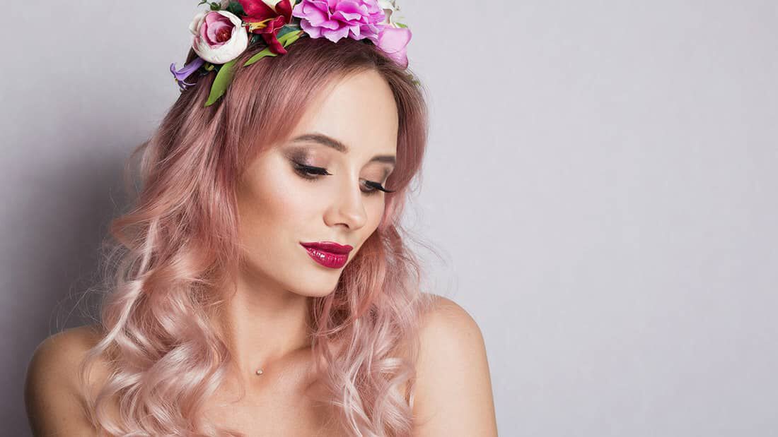 photo of woman with pastel pink hair and a flower crown