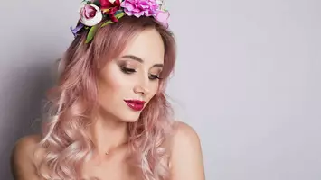 photo of woman with pastel pink hair and a flower crown