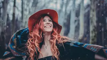 photo of woman with coral hair color pantone color of the year