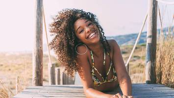 woman with curly hair on beach