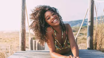 woman with curly hair on beach