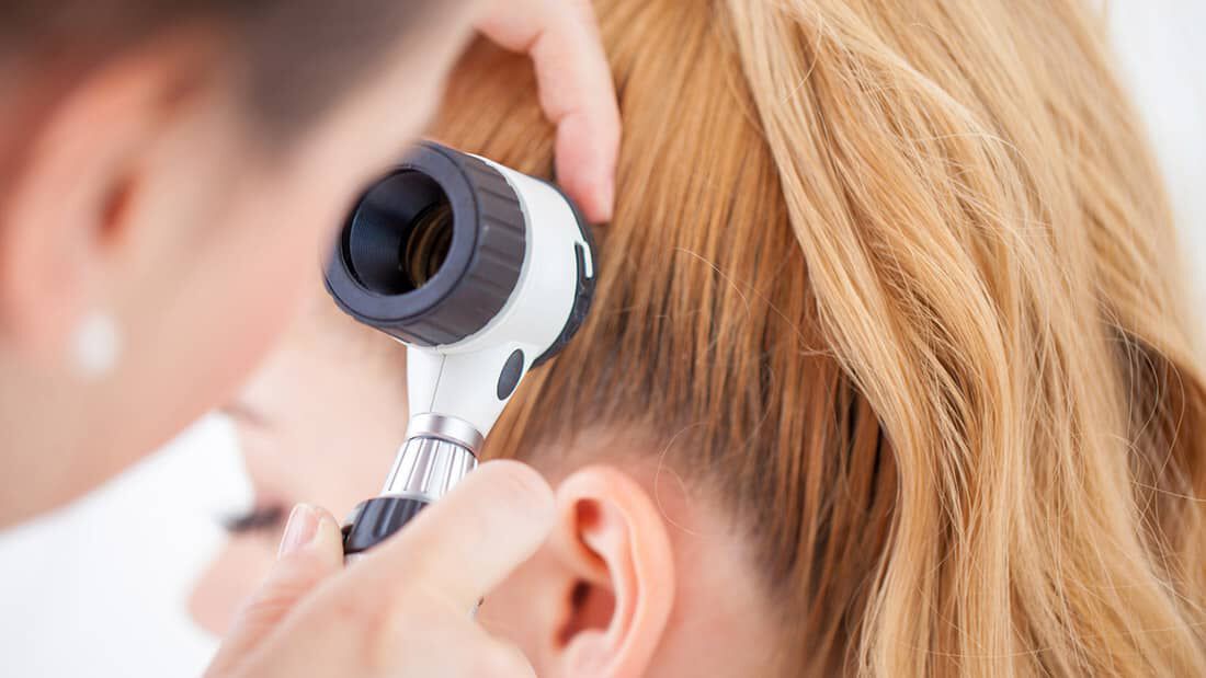 girl getting scalp checked by doctor traction alopecia