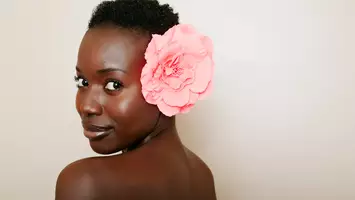 Woman with short hair and flower in her hair