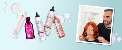 A selection of five haircare bottles against a light blue background, featuring brands like Biolage and Redken, with bubbles scattered around. On the right, a hairstylist adjusts a woman's short red hair, both smiling.