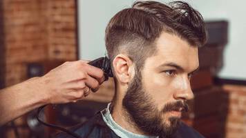 man getting his hair cut