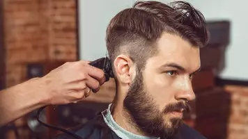 man getting his hair cut
