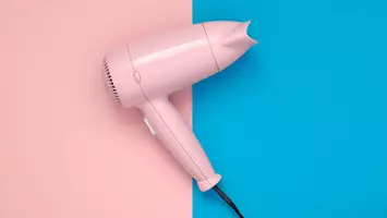 Pink blowdryer on a pink and blue background