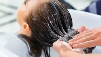 woman using hair lotion