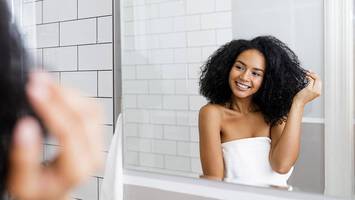 photo of woman in bathroom with natural curly hair