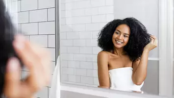 photo of woman in bathroom with natural curly hair