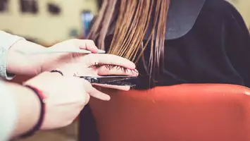 photo of stylist cutting layers for hair