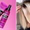 photo of woman in salon getting hair blow dried