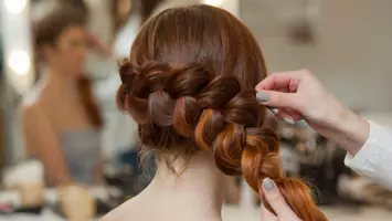 Woman getting dutch braid NEW