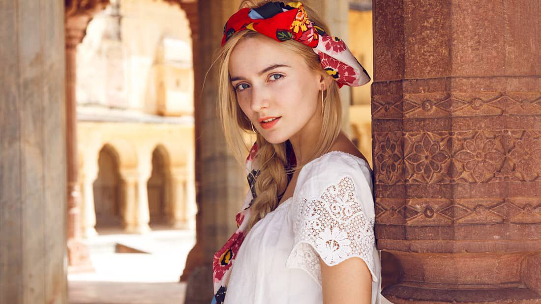 photo of woman with long braided hairstyle and scarf embellishment