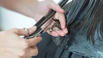 photo of stylist cutting hair in salon