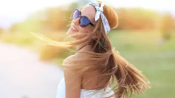 photo of woman with headband long summer hairstyle