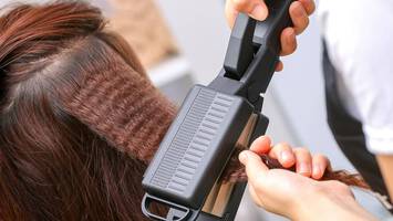 photo of stylist using a hair crimper