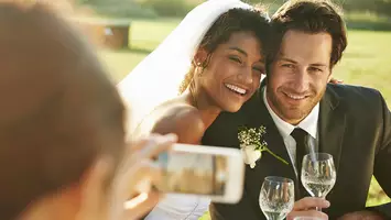 interracial couple cuddles for a photo