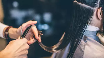photo of stylist cutting hair