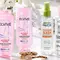 A clean and bright bathroom countertop/sink area featuring various hair accessories like a hair brush, hair clips, comb, scrunchie, etc. Also showing products mentioned in the article like: EverPure Glossing Treatment and Diamond Sleek Spray