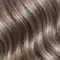 A clean and bright bathroom countertop/sink area featuring various hair accessories like a hair brush, hair clips, comb, scrunchie, etc. Also showing products mentioned in the article like: EverPure Glossing Treatment and Diamond Sleek Spray