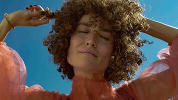 photo of biolage smoothproof shampoo and conditioner and woman with frizzy curly hair
