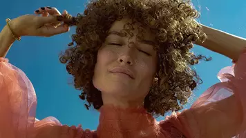 photo of biolage smoothproof shampoo and conditioner and woman with frizzy curly hair