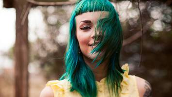 photo of woman with neon green baby bangs hairstyle