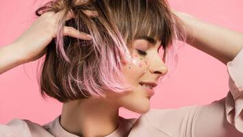 photo of woman with pink balayage hair color and bob haircut