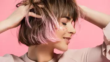 photo of woman with pink balayage hair color and bob haircut